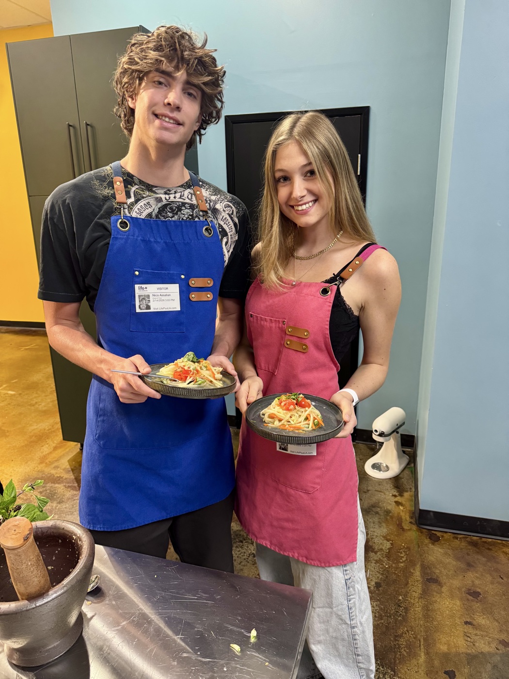 A couple with the dish they made